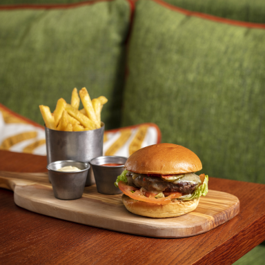 A plate with a burger and fries on a table