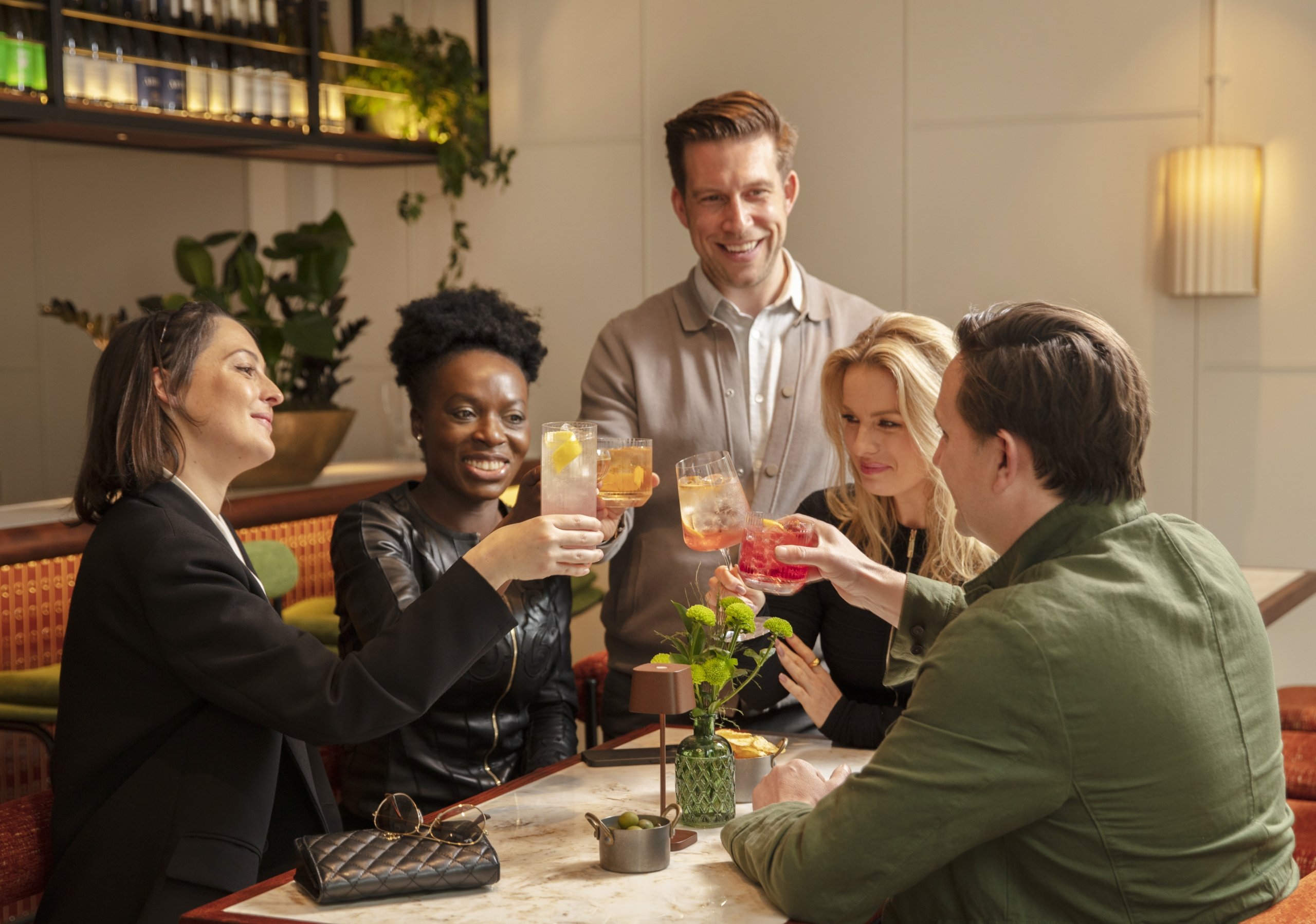 group of friends all enjoying happy hour at the cardinal