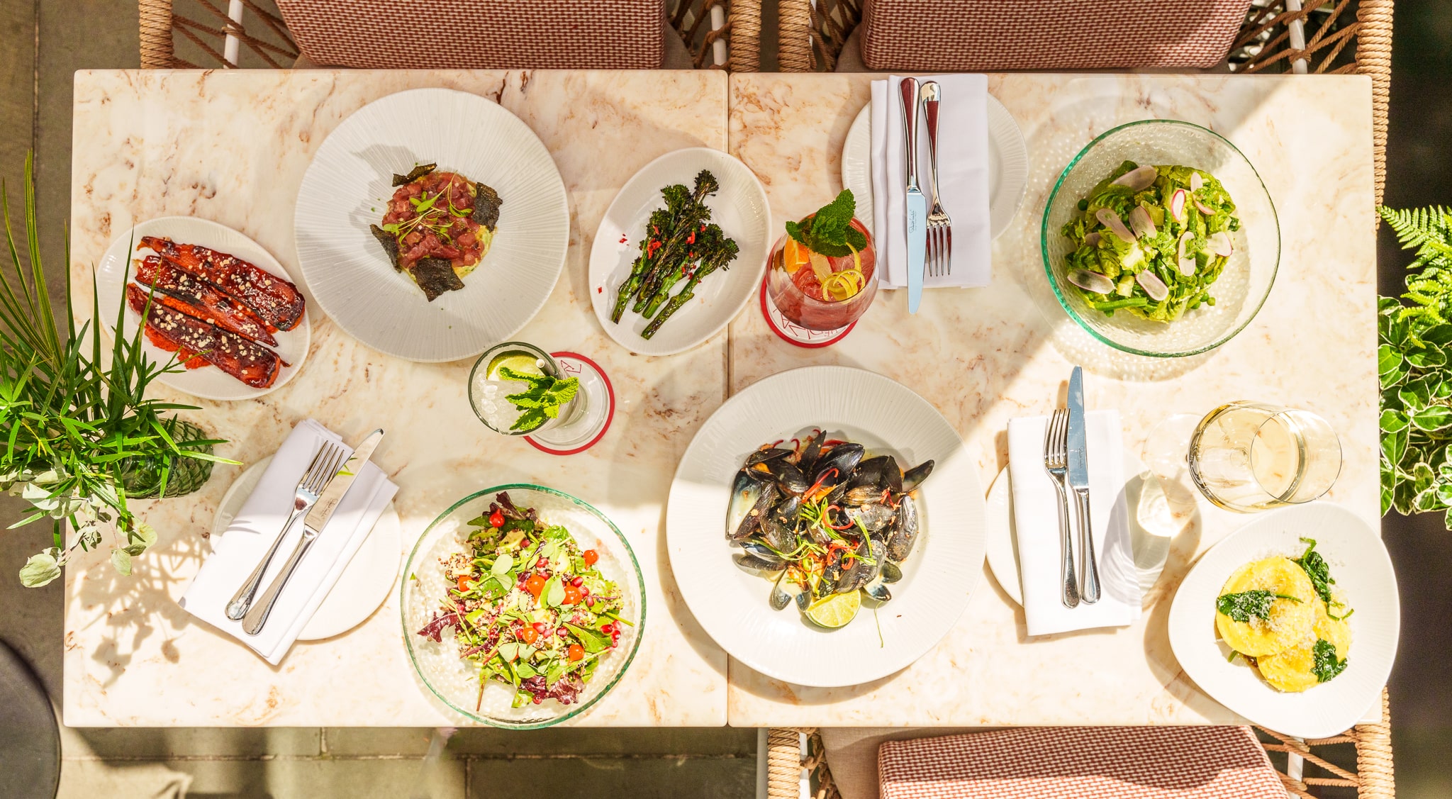 full table with drinks, seafood and salad