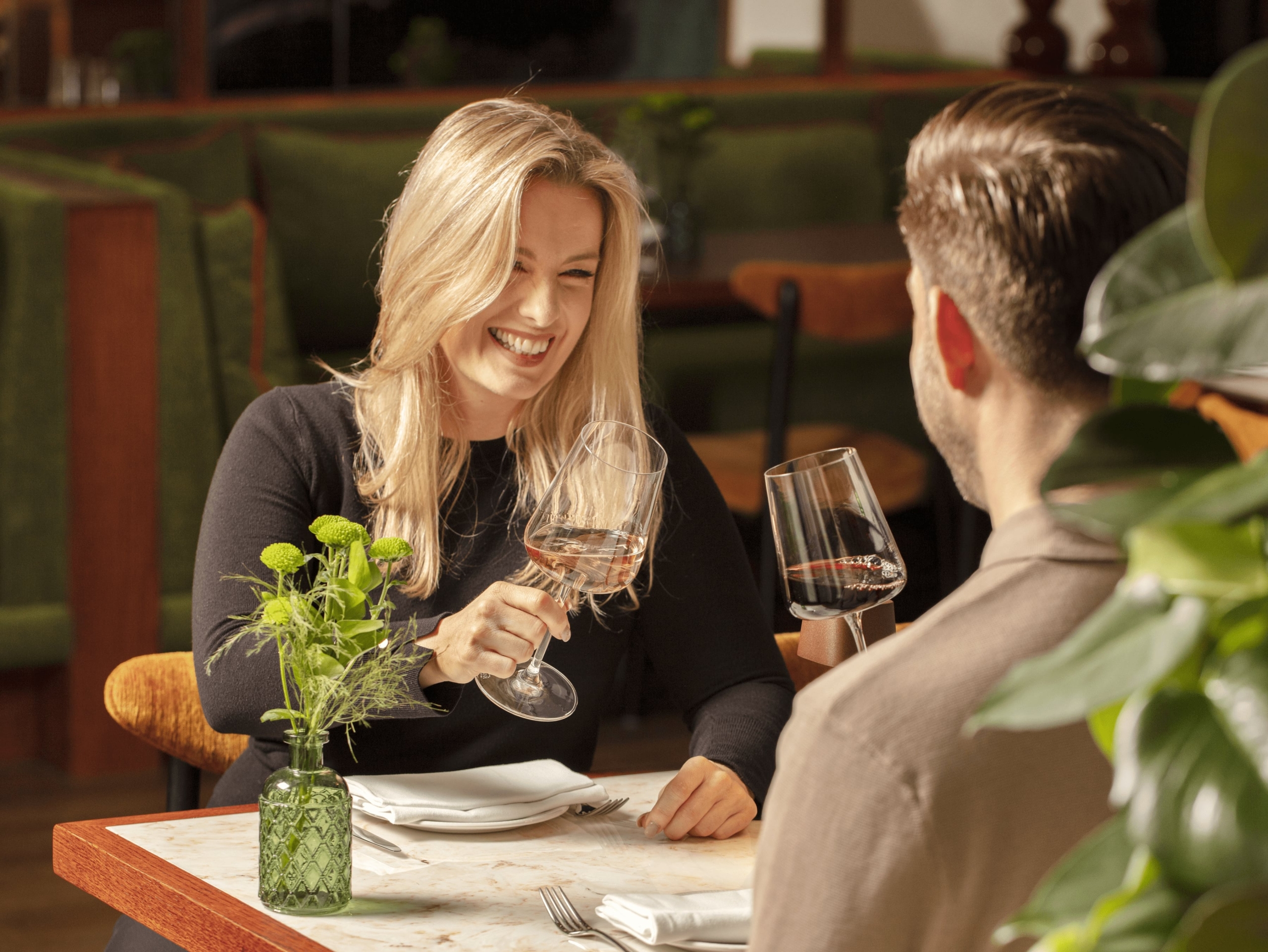 Two people enjoying a conversation and wine