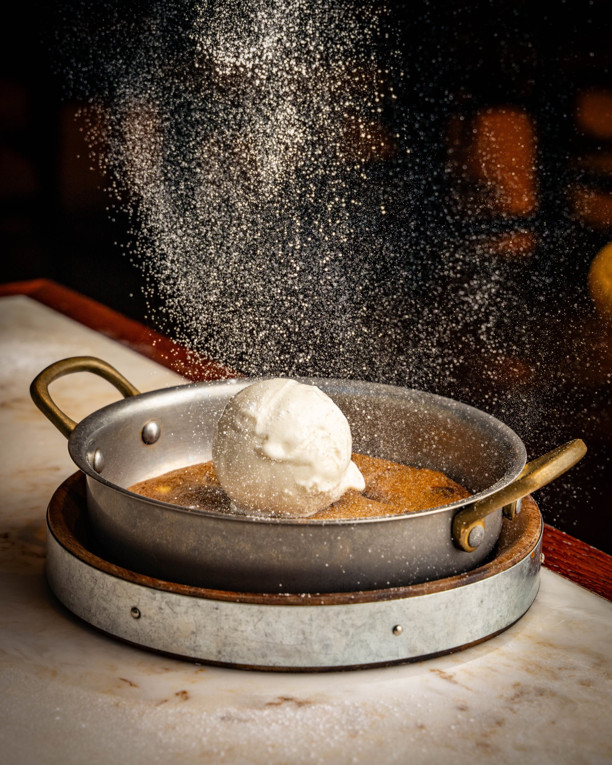 icing sugar being put on a desert