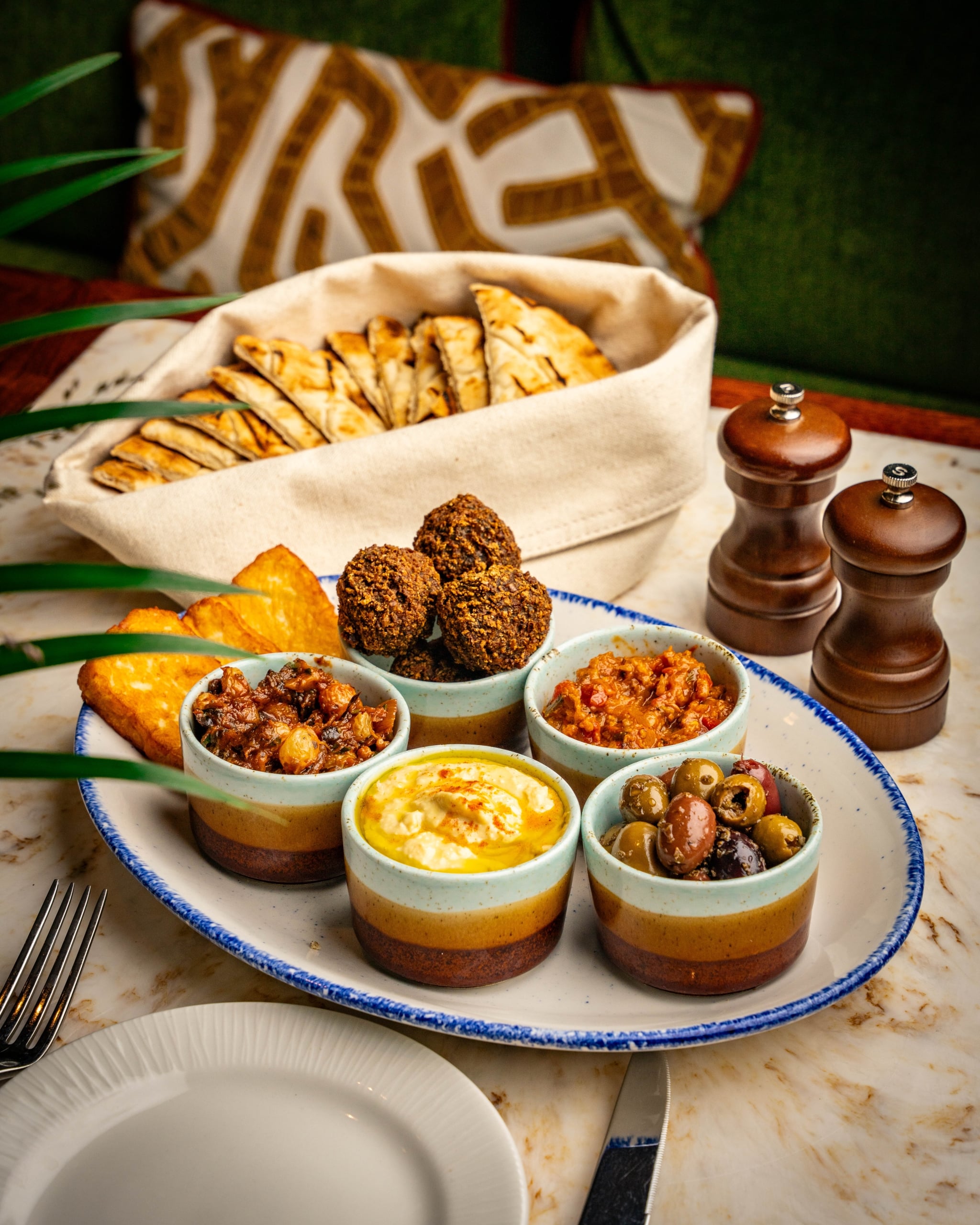 Plate of food with individual bowls of food on it prepared by The Cardinal
