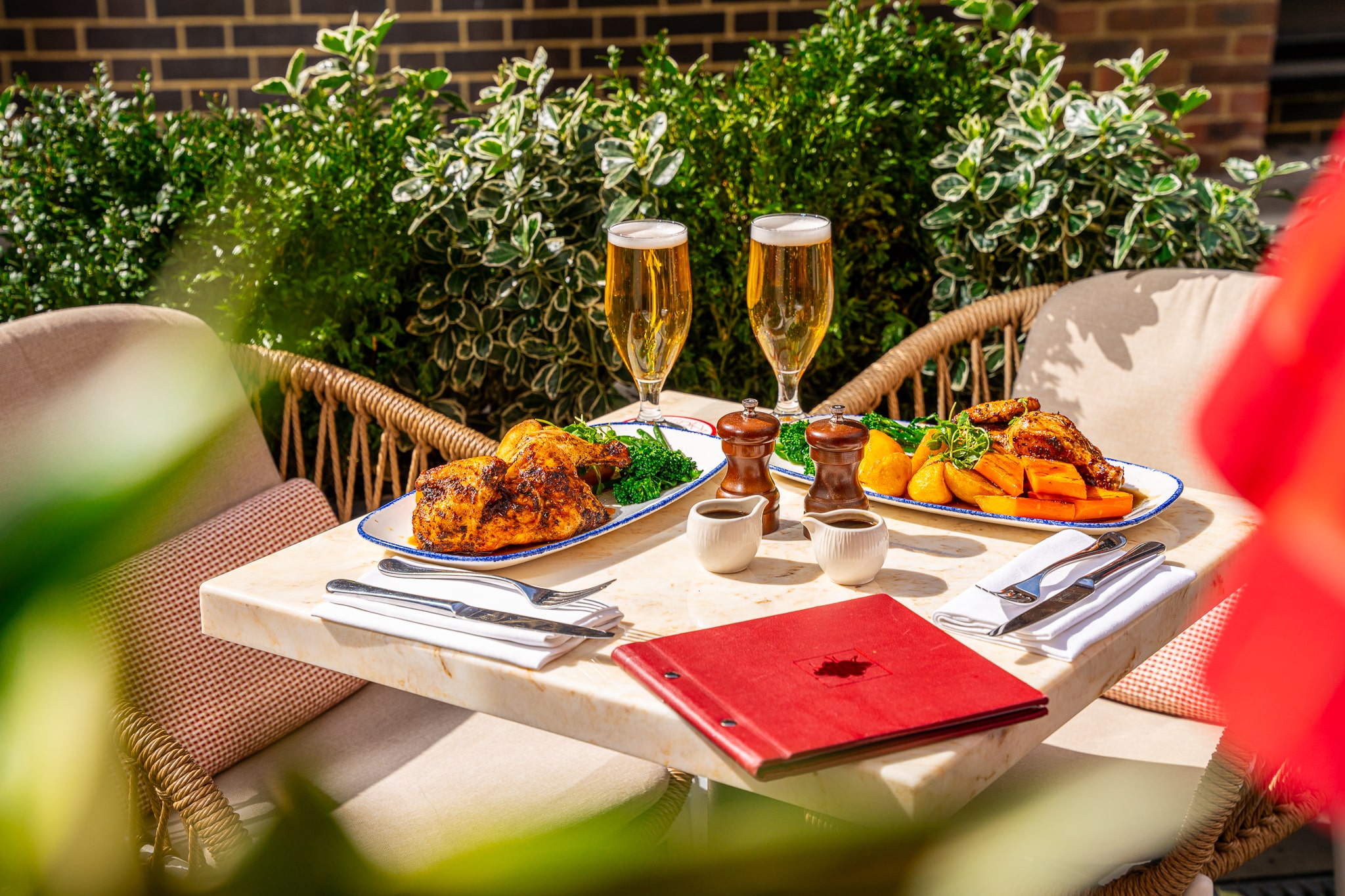 The Cardinal Bar & Kitchen Outdoor Dining with two plates set